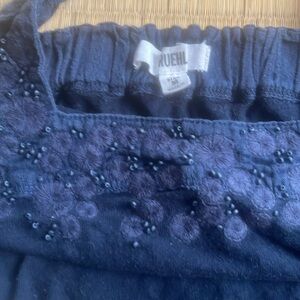 Sleeveless dark blue halter. Embroidery and seed pearls at neckline.